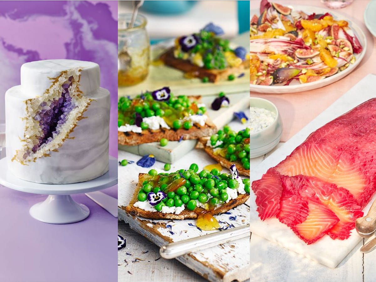 a display of a decorative cake and various gourmet dishes