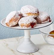 jelly donuts on white cake stand