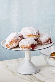 jelly donuts on white cake stand