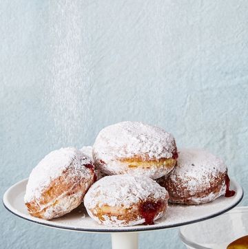 jelly donuts on white cake stand