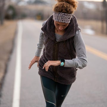 woman running and looking heart rate on watch woman running and looking heart rate on watch