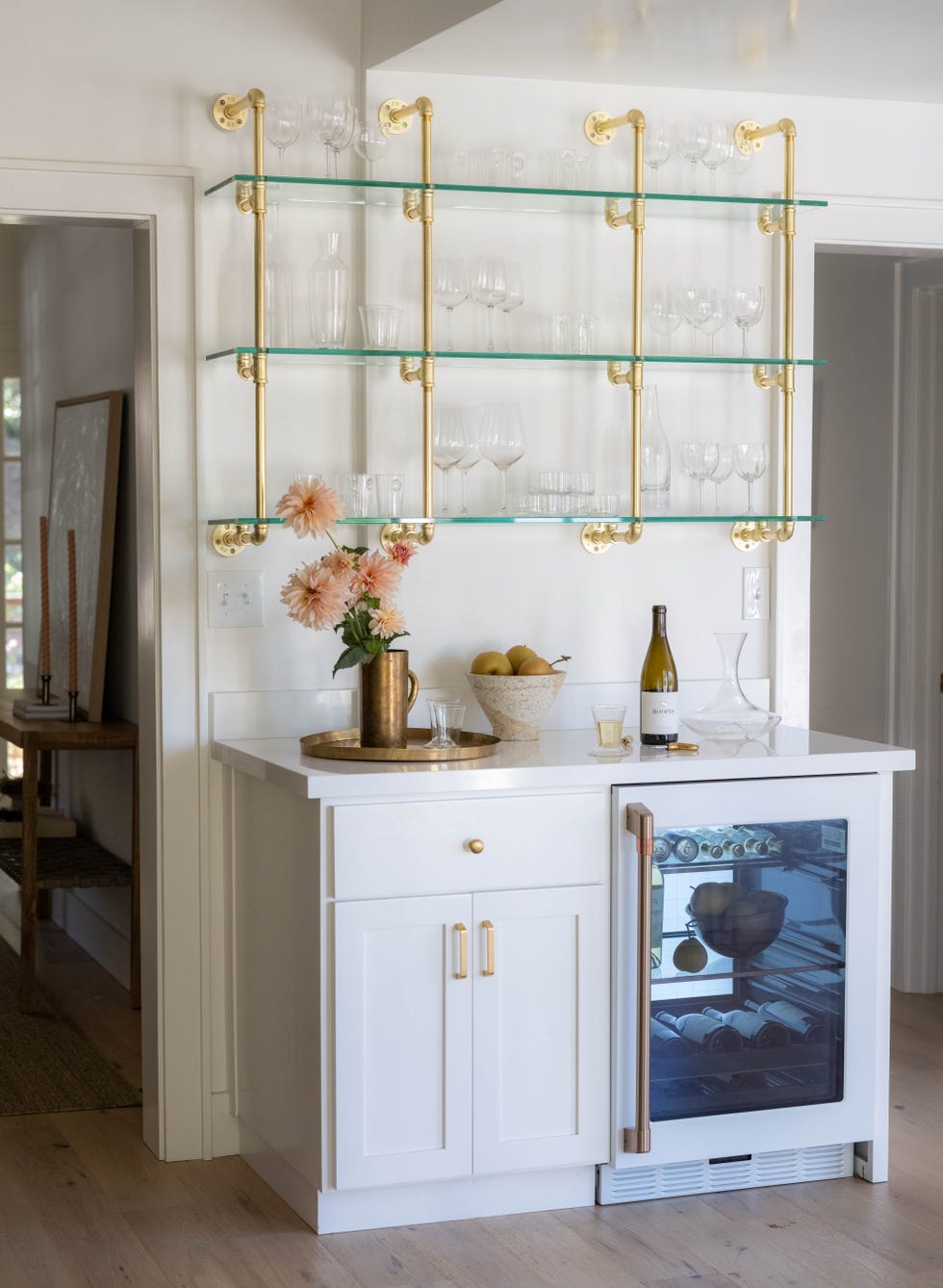 a white cabinet with glasses and bottles