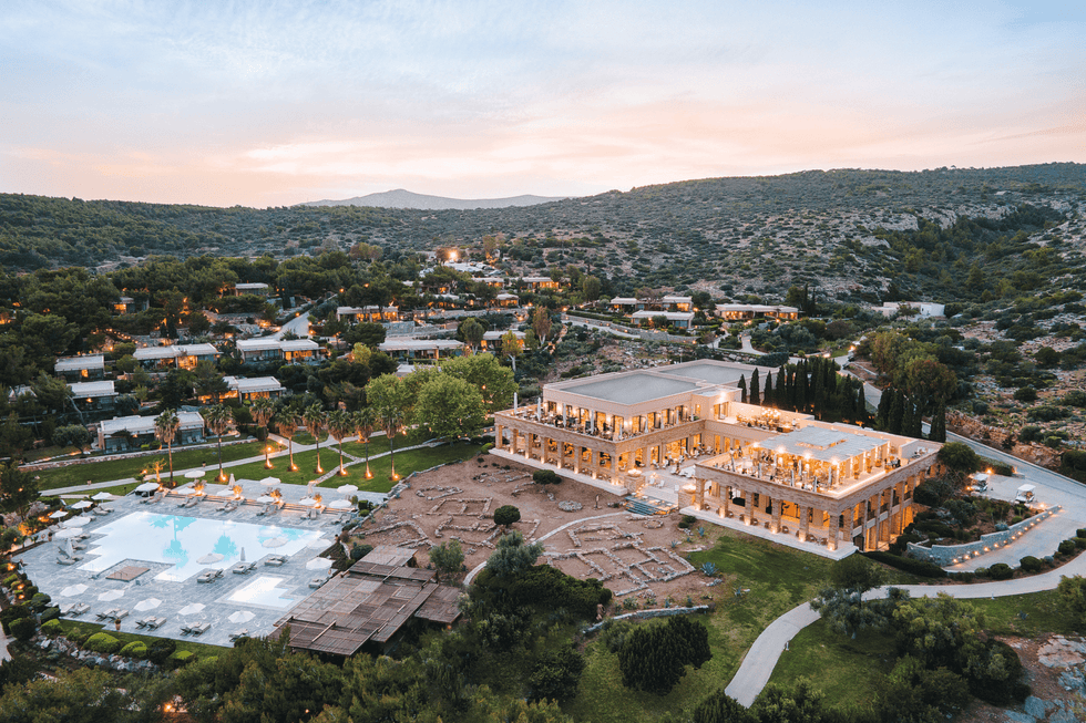 a large building with a pool in front of it