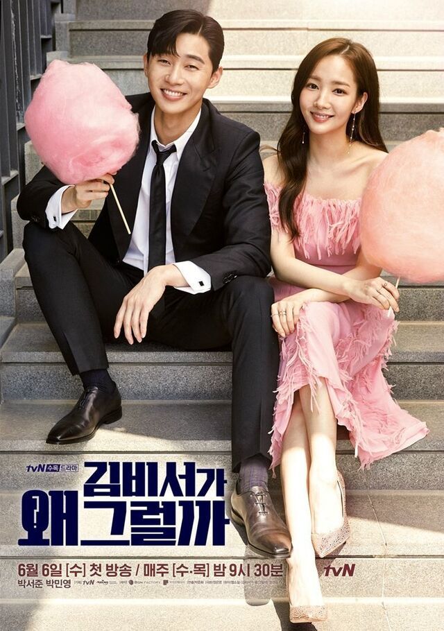 a man and woman posing for a picture with a large pink balloon