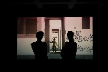 two women in front of screen francis alys barbican 2024 exhibition