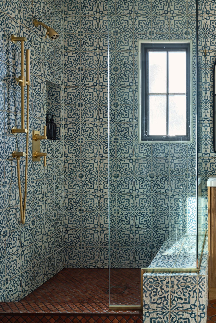 a contemporary bathroom featuring intricate blue and white patterned tiles covering the walls a contemporary bathroom featuring intricate blue and white patterned tiles covering the walls