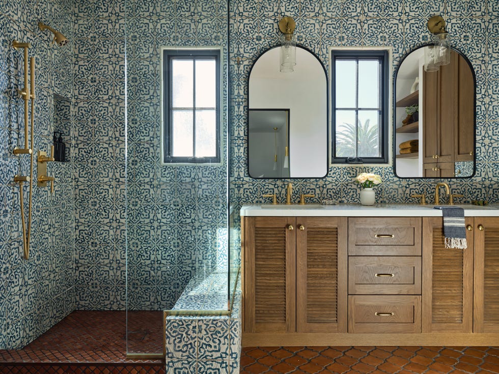 a contemporary bathroom featuring intricate blue and white patterned tiles covering the walls