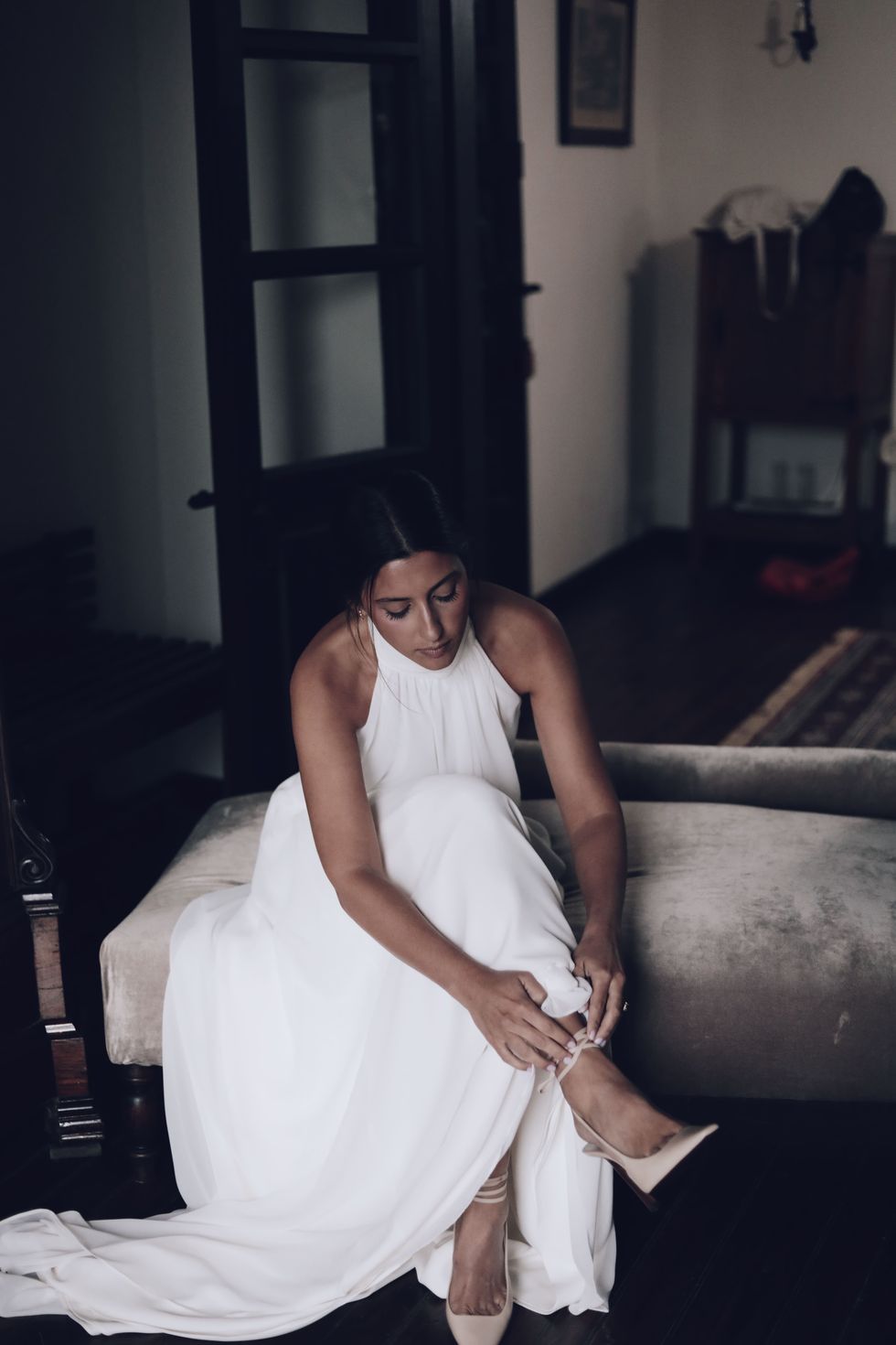 a person in a white dress sitting on a couch