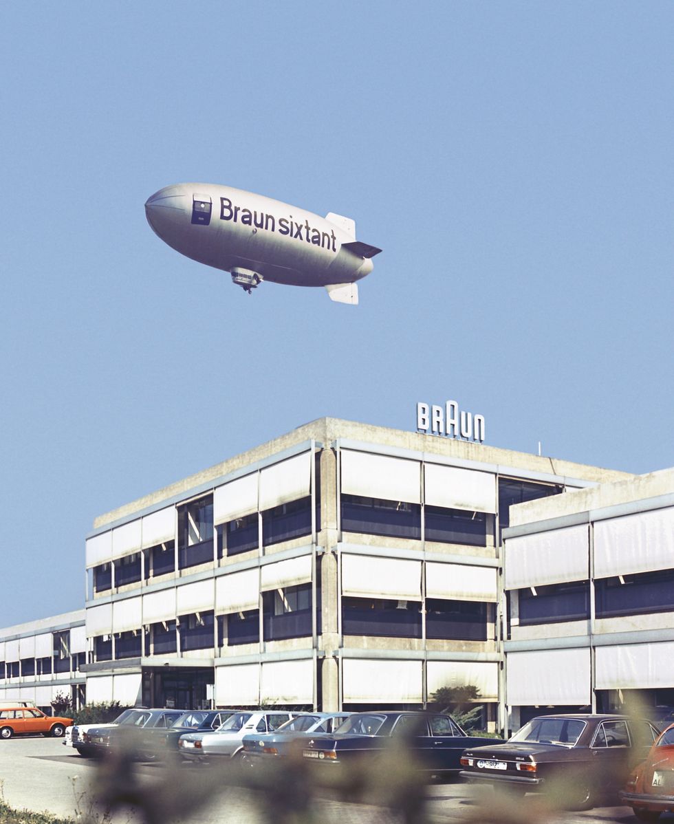 a blimp flying over a building