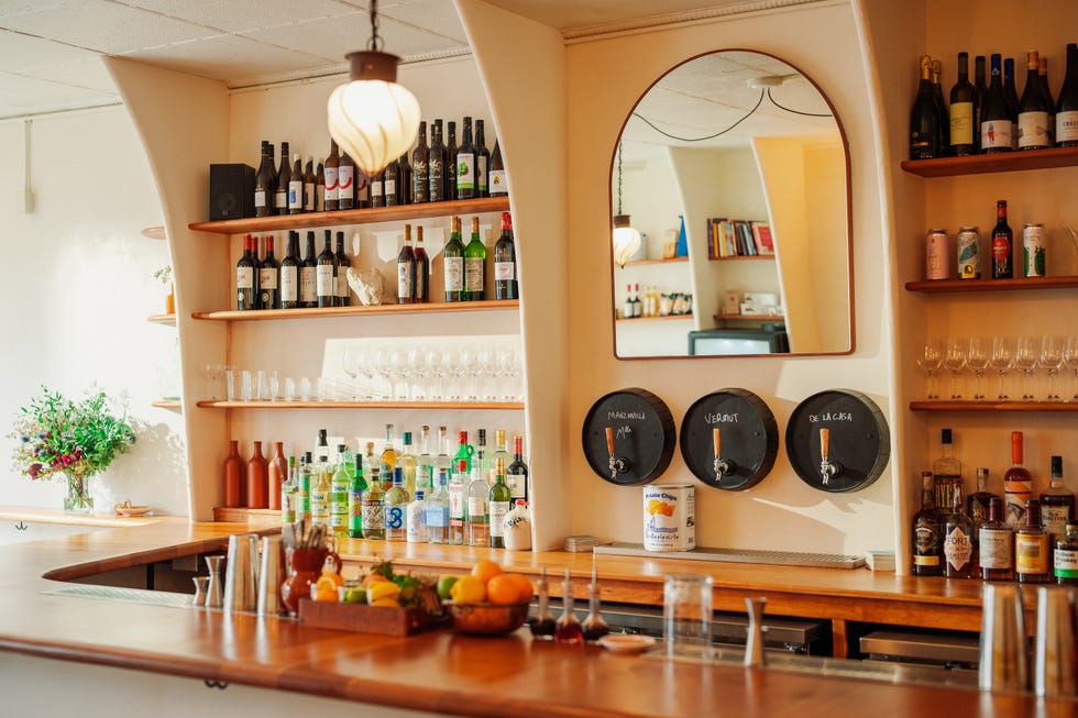 a kitchen with shelves full of wine