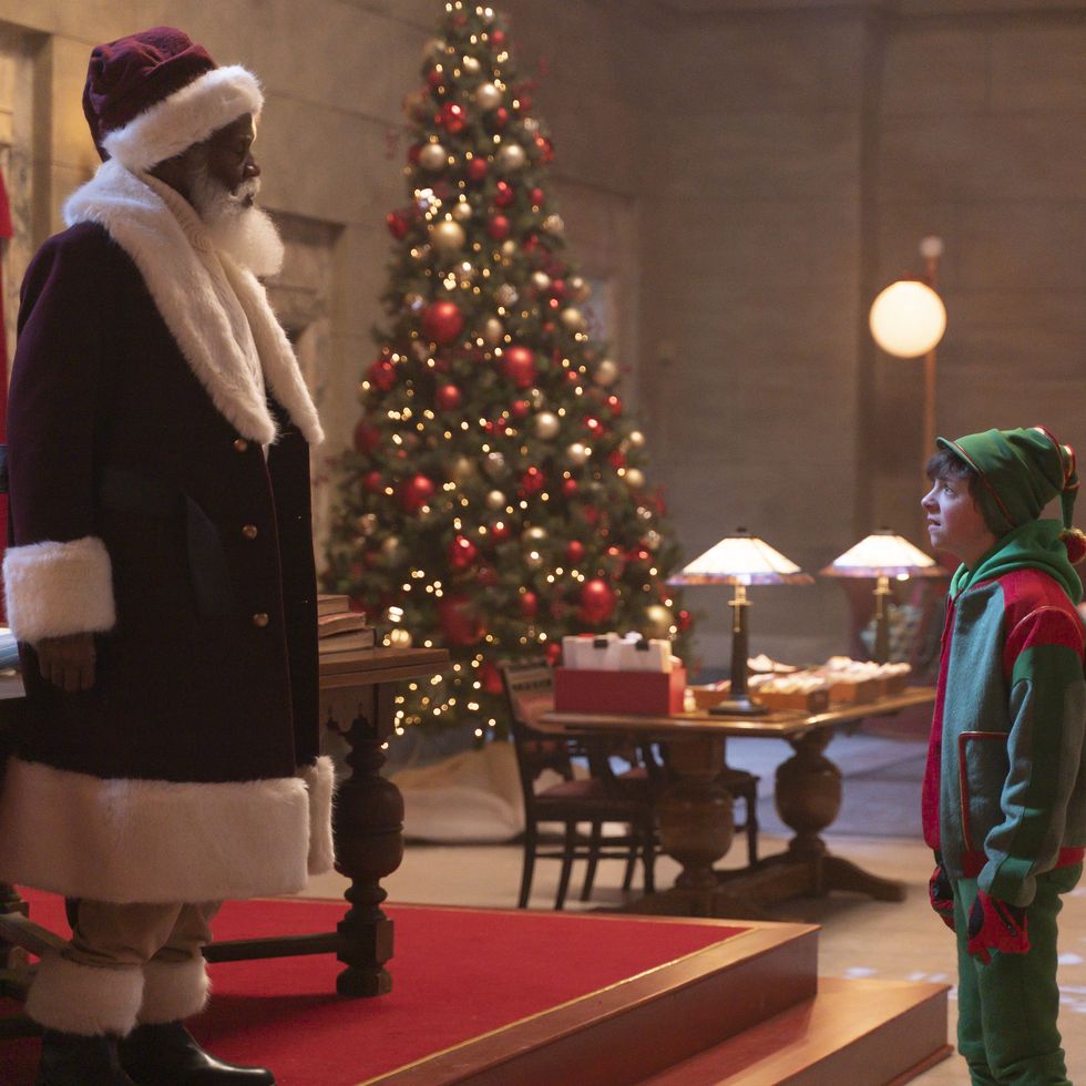 danny glover as santa looks down on a child in a scene from the naughty nine