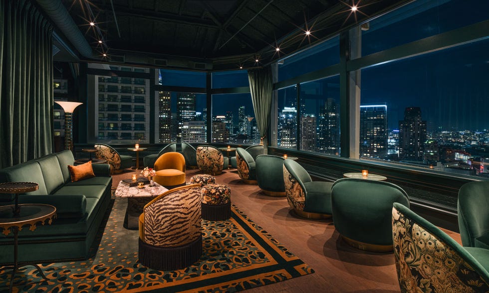 a room with a large window and a large city landscape