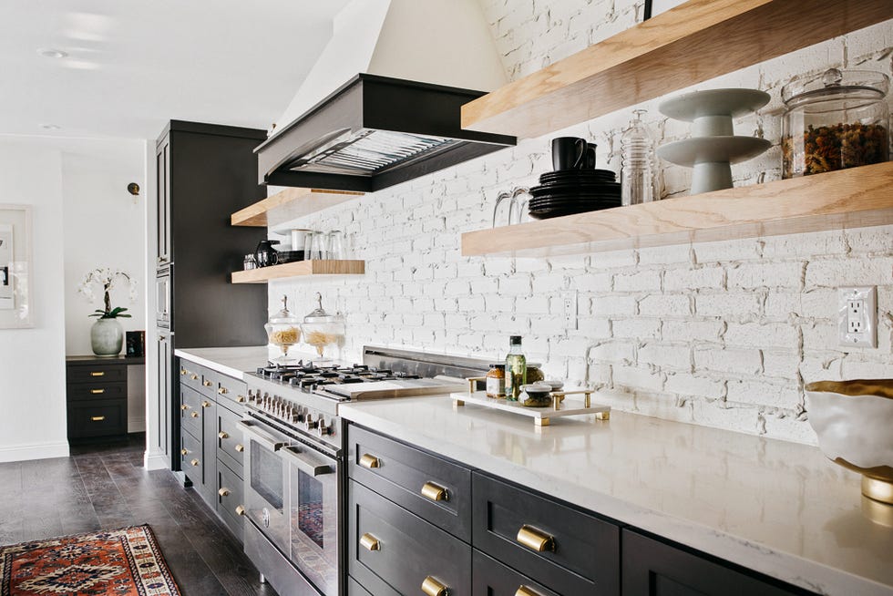 a kitchen with a white exposed brick backsplash