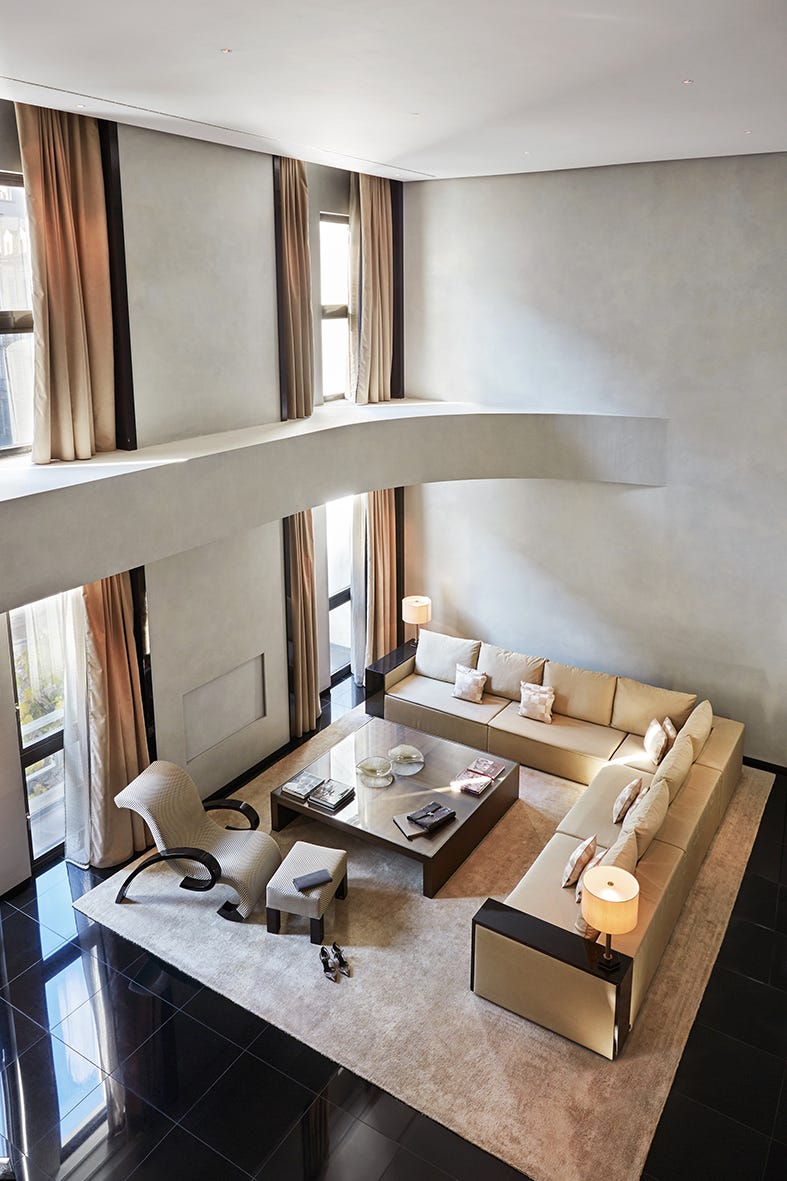 modern living room with large sectional sofa, coffee table, and ample natural light