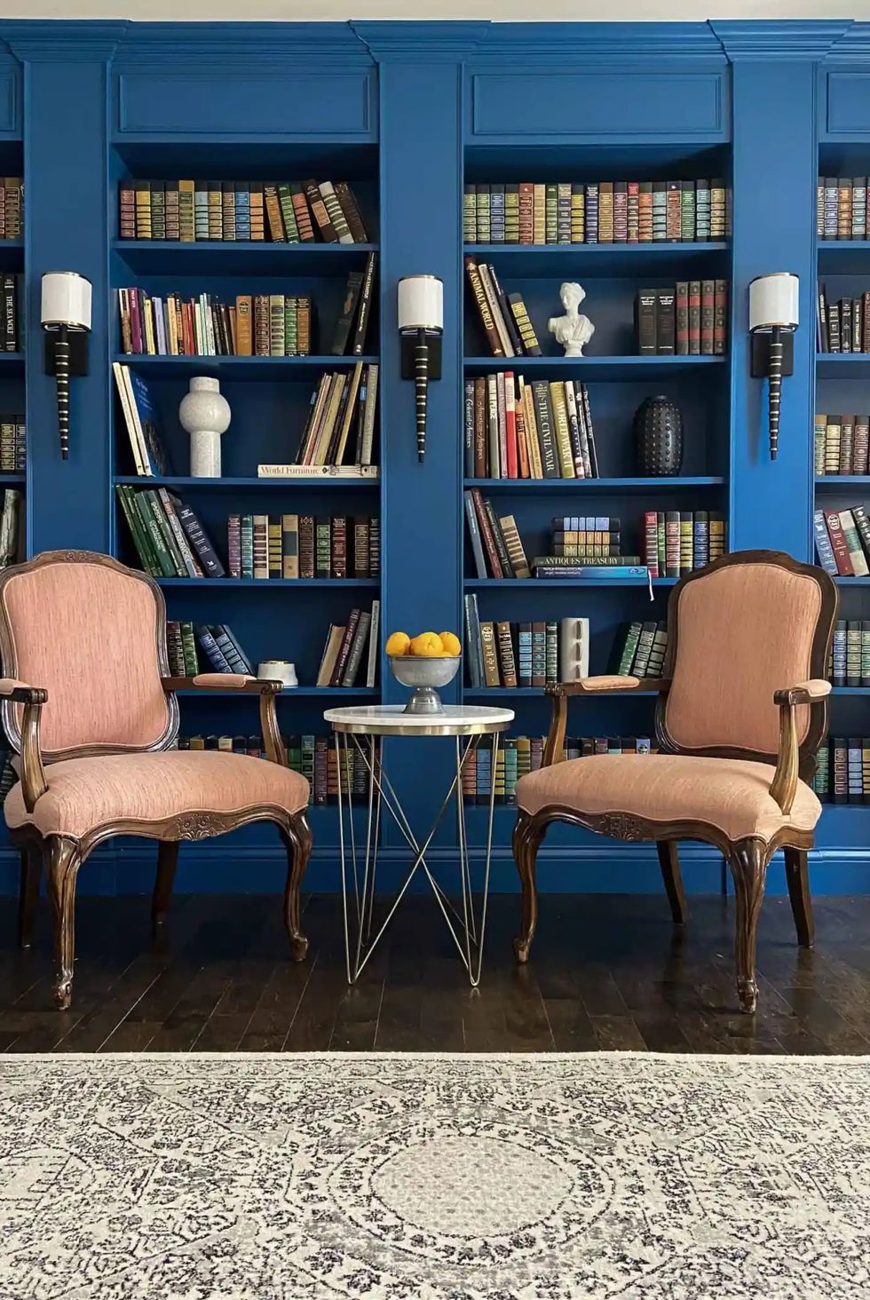 some chairs in front of the bookshelf