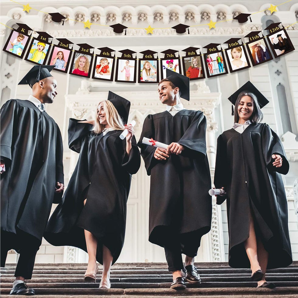 graduates in front of banner