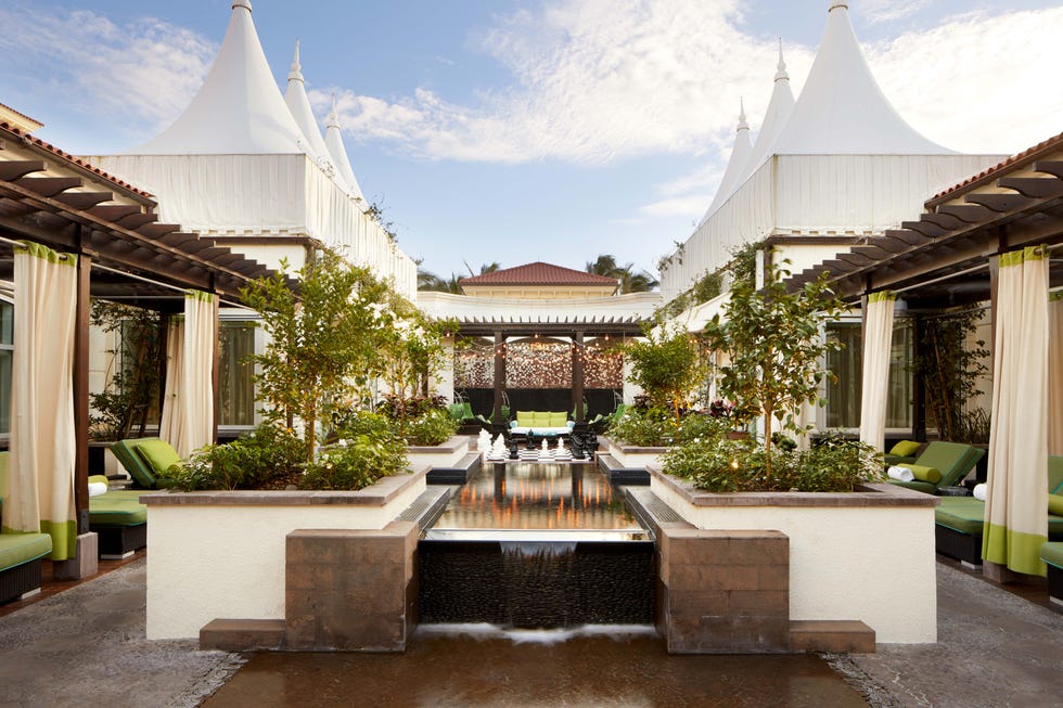 a courtyard with a fountain and buildings