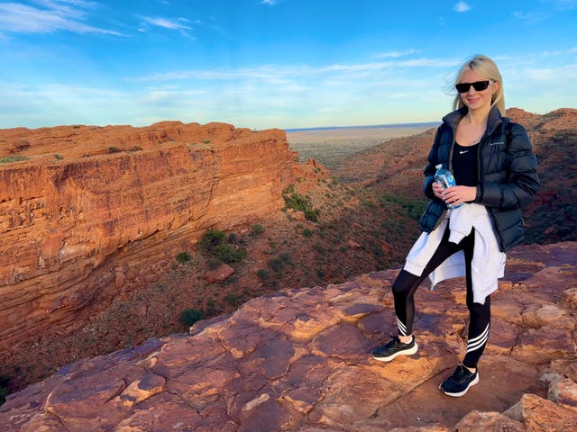 nathalie whittle standing on a rock surveying a canyon in australia northern territories