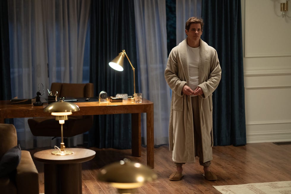 a person standing in a cozy room wearing a robe