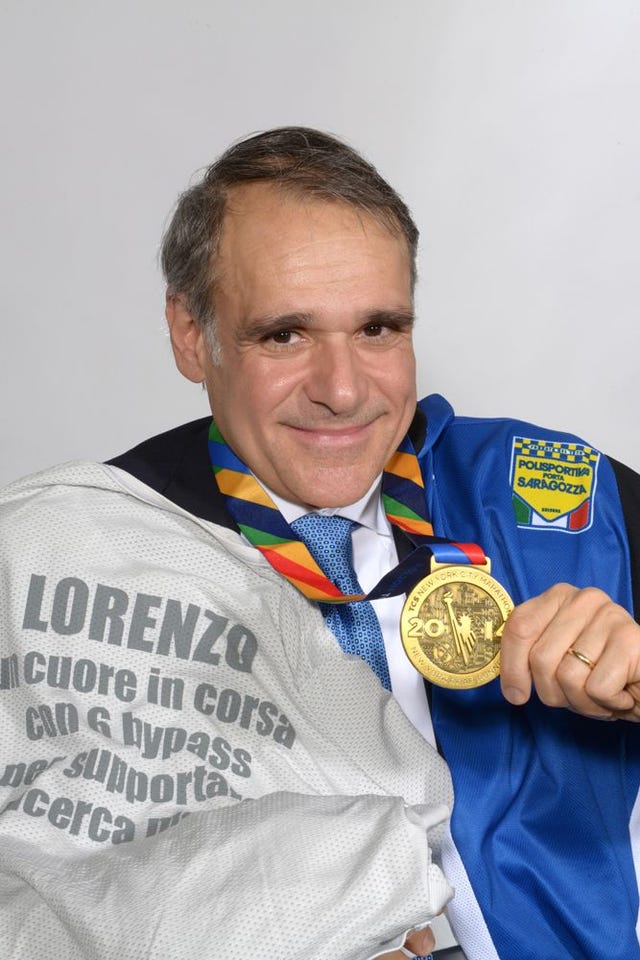 person holding a medal and wearing a jersey with a shirt expressing a supportive message