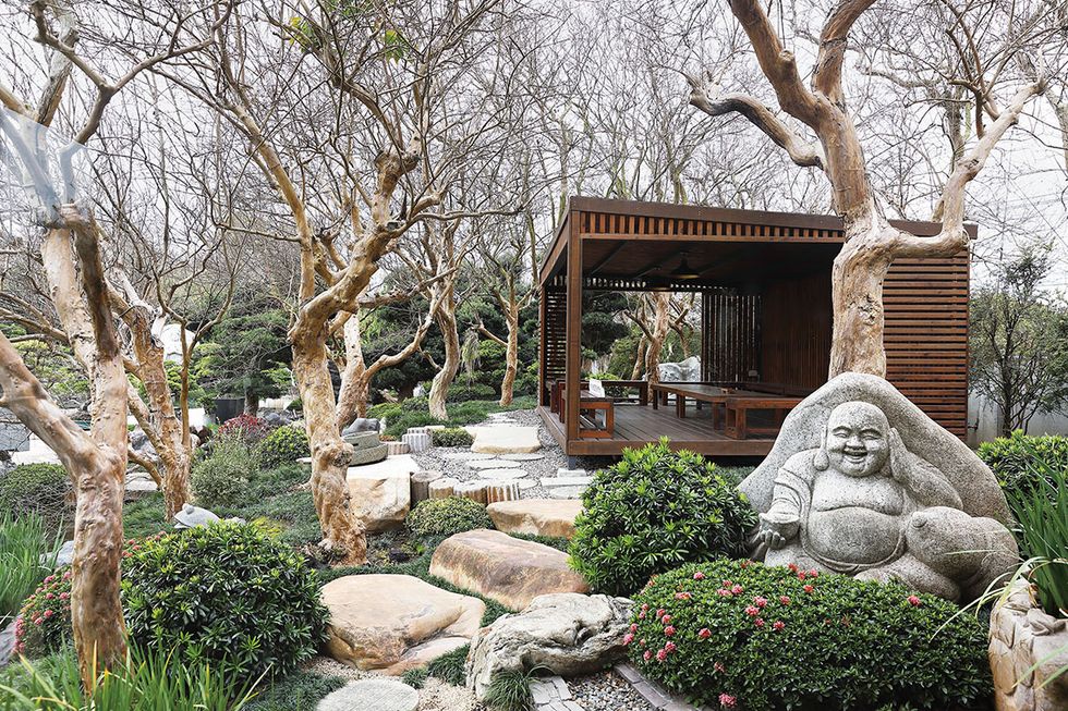 a garden with a statue
