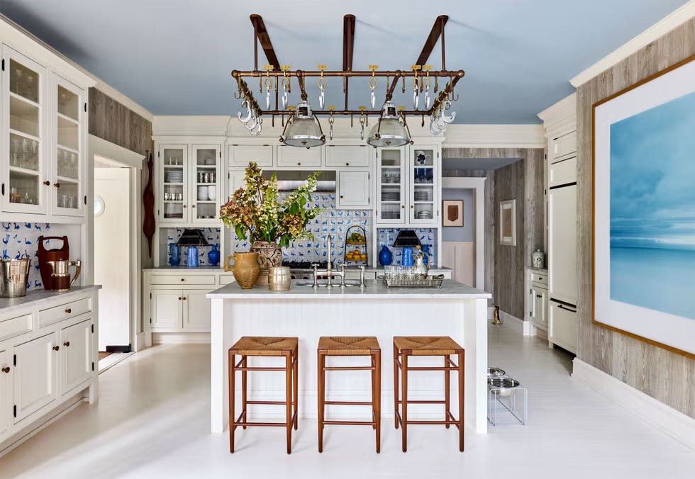 bright and spacious kitchen with island and bar stools