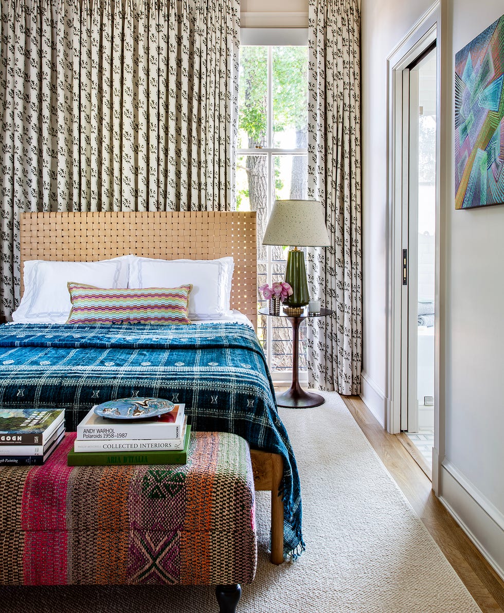 stylish bedroom showcasing a bed decorative textiles and natural lighting