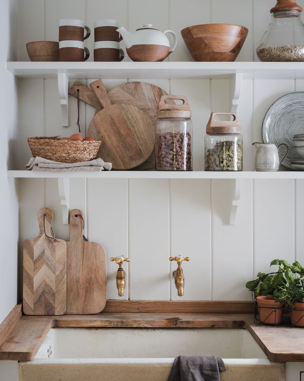 open kitchen shelving with glass jars and wooden boards
