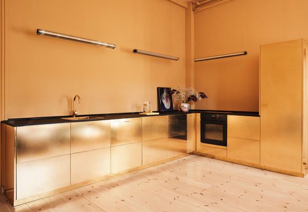 Learn more about Reform creating a customised IKEA kitchen for Stine Goya: starting from the Swedish brand's standard cabinetry, a 100% shiny brass kitchen was born.
