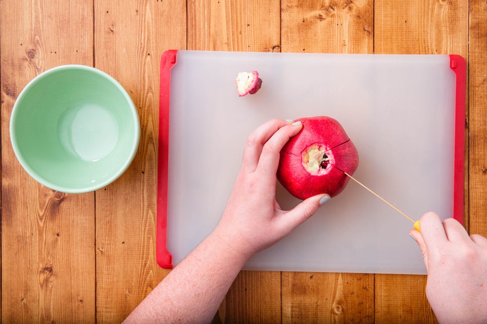 Food, Apple, Fruit, Plate, Pomegranate, Hand, Plant, Cutting board, Breakfast, Superfood, 