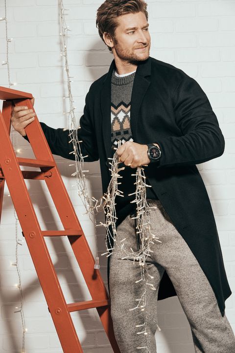 A man hanging Christmas lights