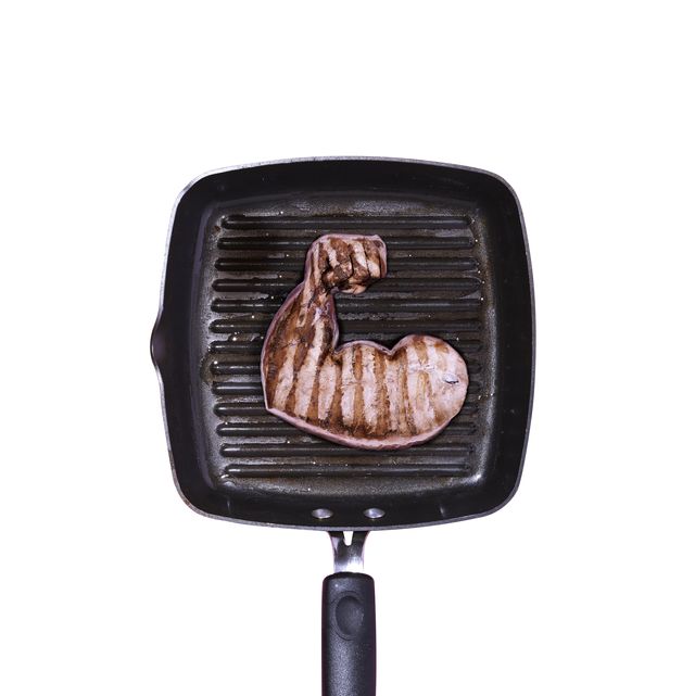 a griddle pan with a piece of meat in the shape of a arm flexing its muscles