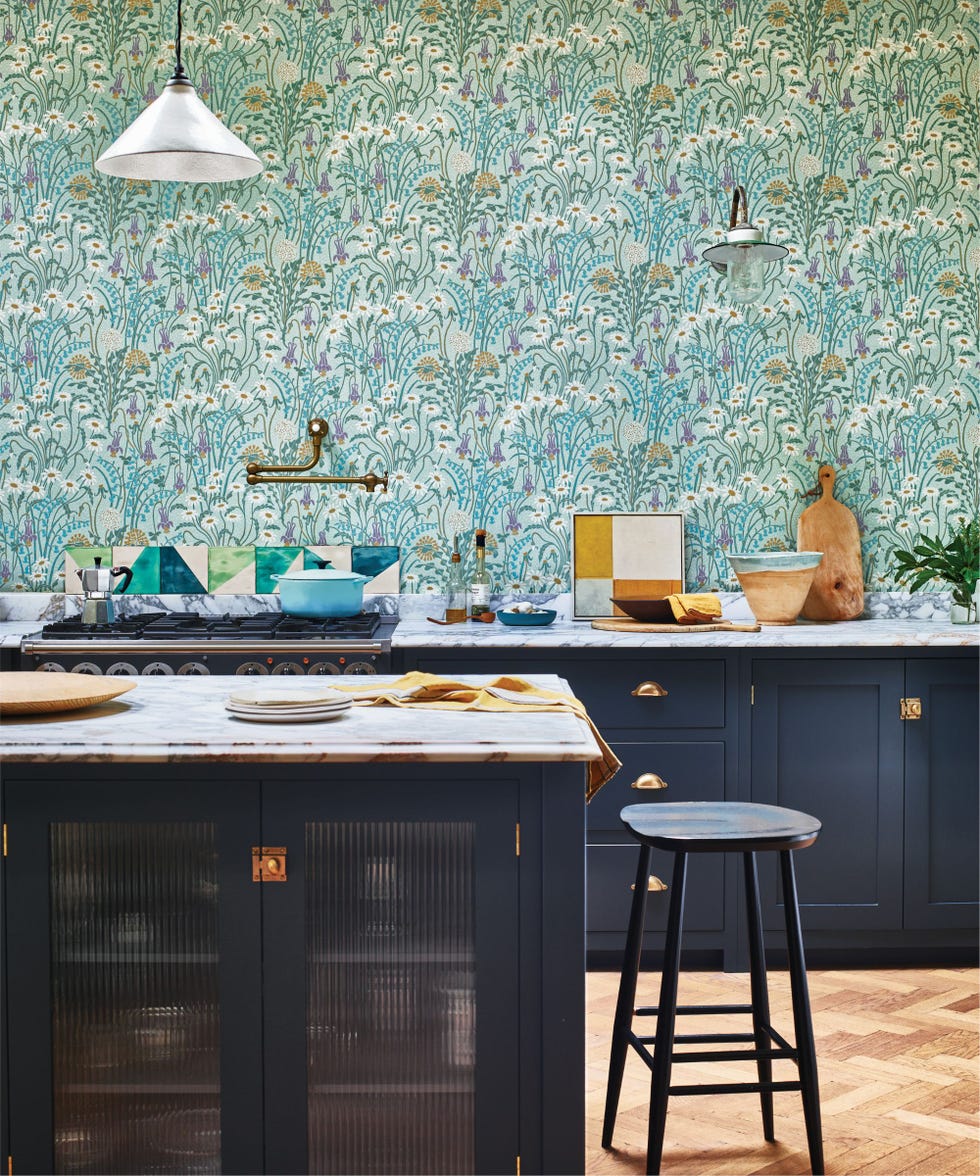 blue Shaker kitchen with marble countertops and floral wallpaper up to the ceiling