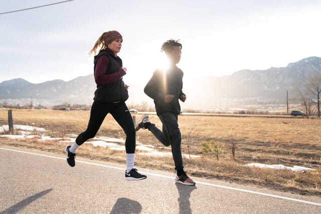 a woman and man running side by side