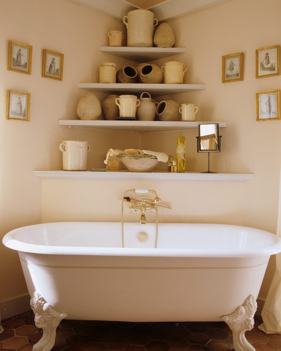 provence bathroom provence bathroom with ornate tub and corner shelves that feature a variety of pottery