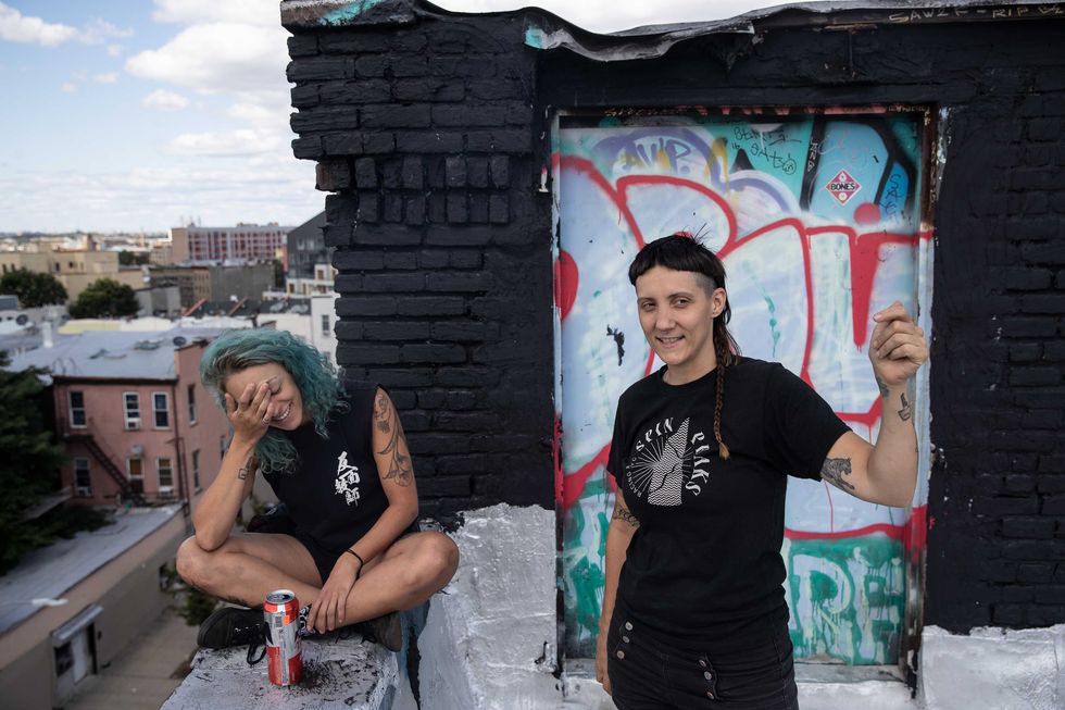 Kit Melton, 27, and Cheylene Tattersall, 34, right, hang out on Cheylene's roof in Brooklyn, NY, Saturday, Aug. 24, 2019.