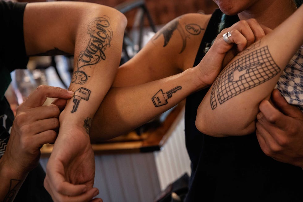 Kit Melton, Cheylene Tattersall and Christy Rappold display memorial tattoos for Robyn Hightman on Saturday, August 24, 2019.