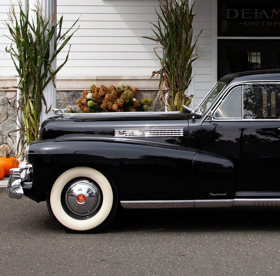 a black car parked in front of a building