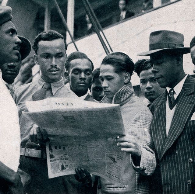jamaican men on board the empire windrush who have come to britain to seek work some of the men, dressed smartly in jackets and ties, are reading a newspaperjune 1948