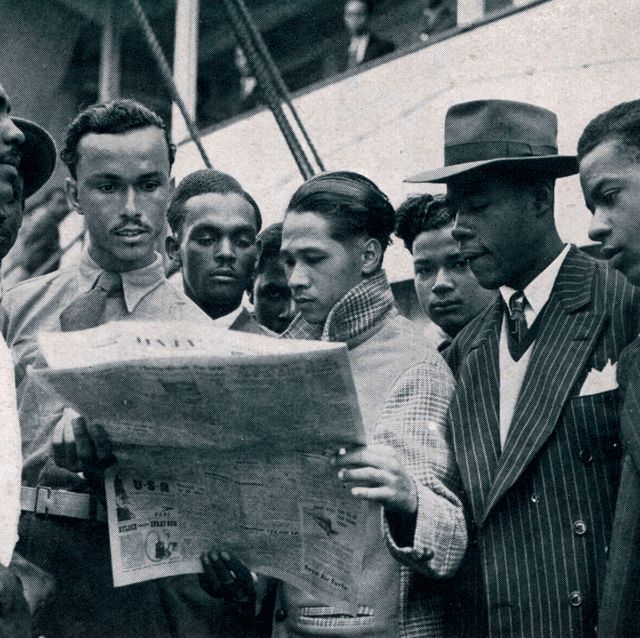 jamaican men on board the empire windrush who have come to britain to seek work some of the men, dressed smartly in jackets and ties, are reading a newspaperjune 1948