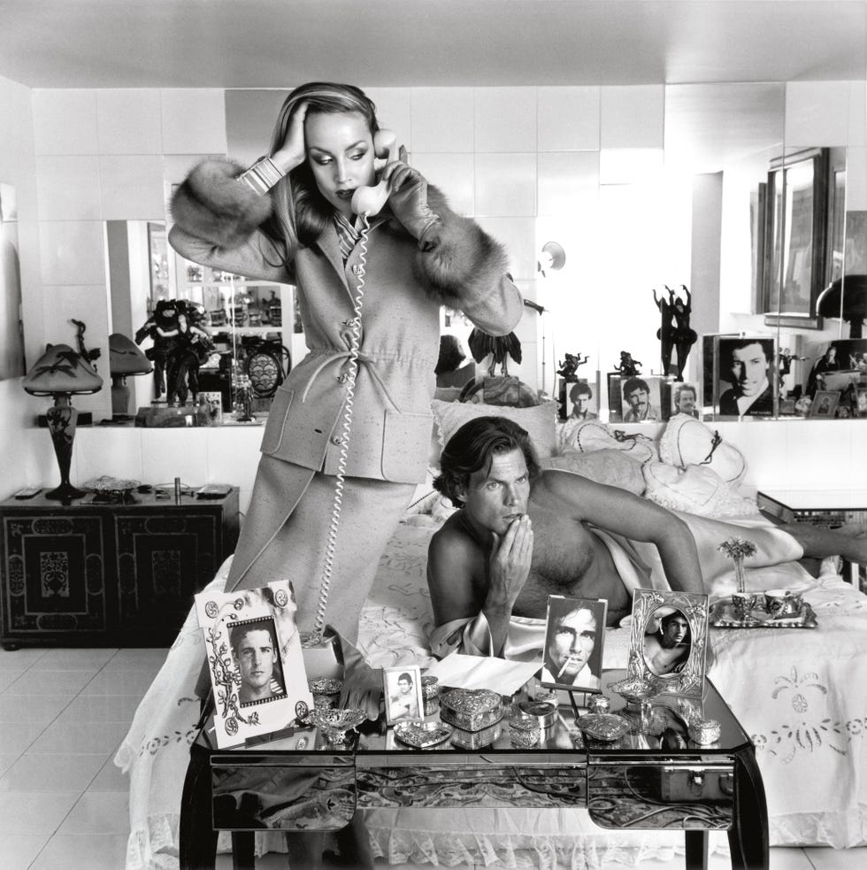 a couple engaged in a private moment within a stylish bedroom defined by decorative items and contrasting lifestyles