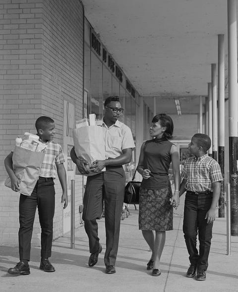 vintage photos of grocery stores   family leaving grocery store