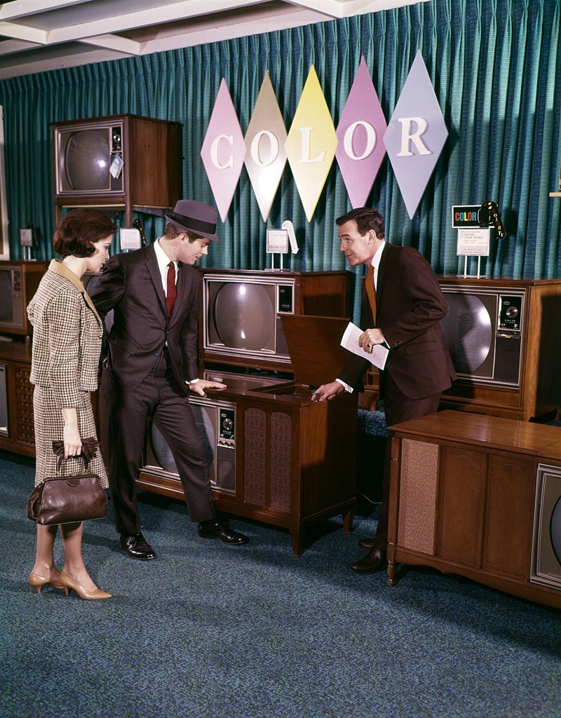 1960s couple with salesman