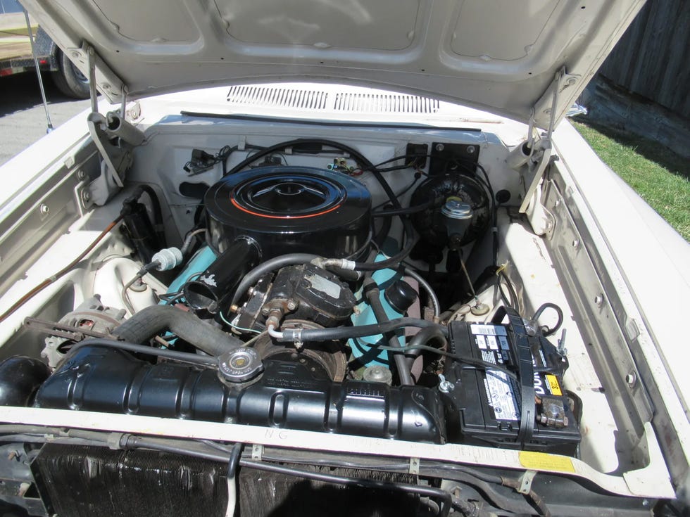 engine bay of a 1962 dodge polara 500, featuring a v8 engine with visible components and wiring.