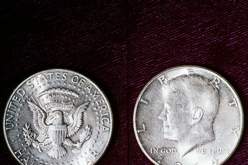 the back and front side of an american half dollar, the silver coin features an eagle on the back and john f kennedy facing left on the front