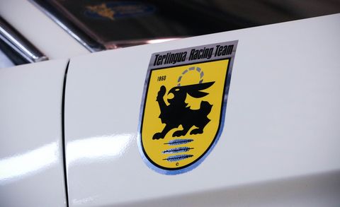 Motor vehicle, Emblem, Yellow, Vehicle, Symbol, Logo, Car, Sticker, Graphics, Vehicle door, 
