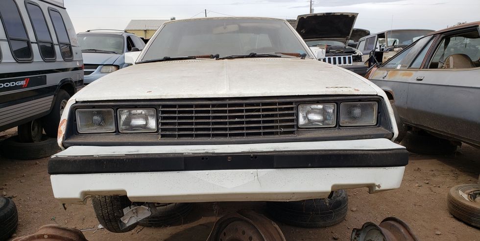 1983 dodge charger and 1982 dodge challenger in colorado wrecking yard