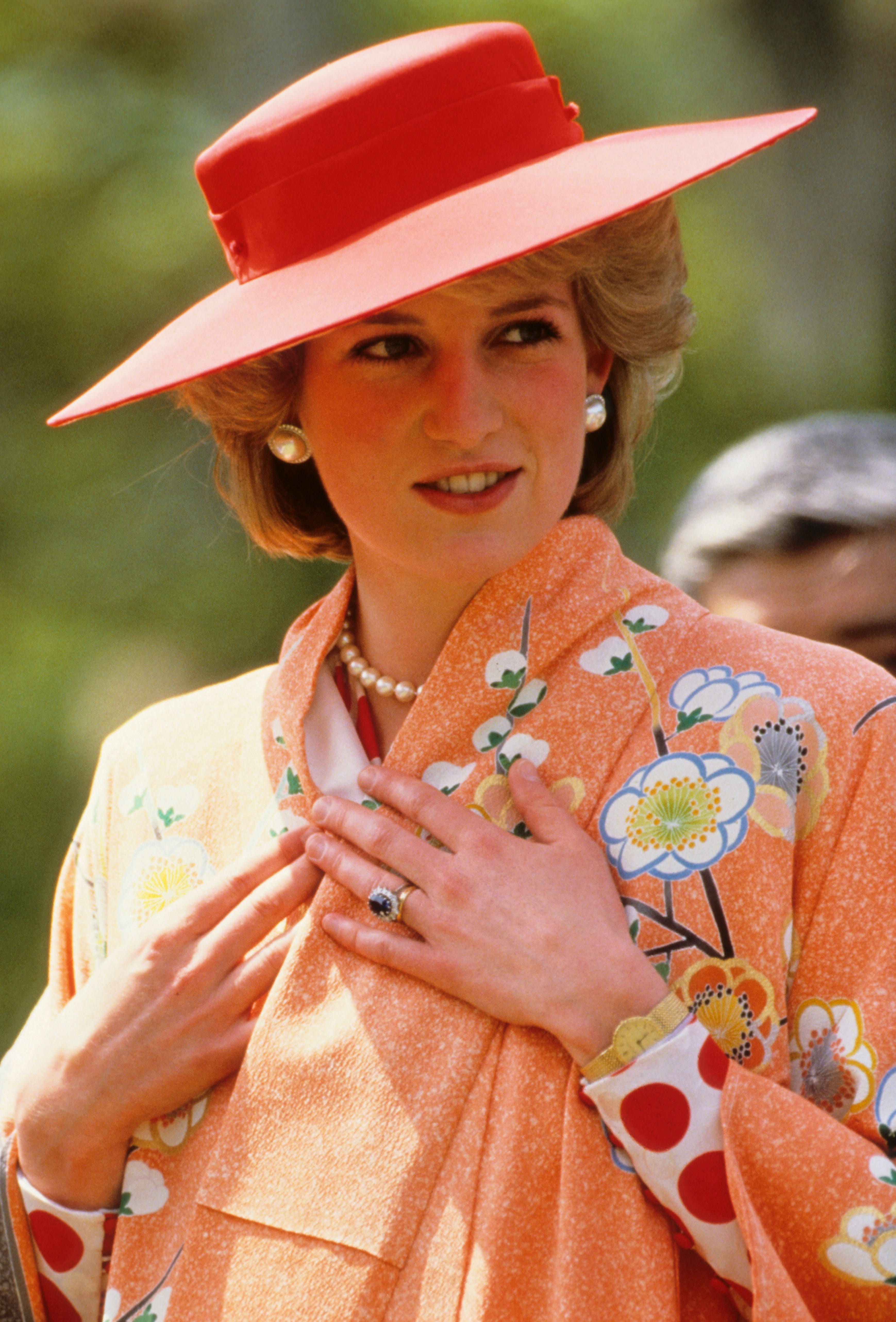 Princess Diana trying on a kimono that she received as a gift at Nijo Castle, Kyoto, during an official visit to Japan on May 1986