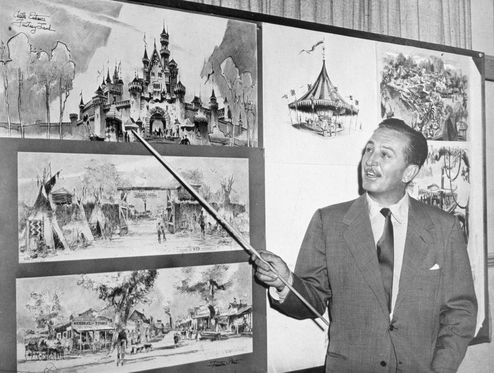 american producer, director, and animator walt disney uses a baton to point to sketches of disneyland