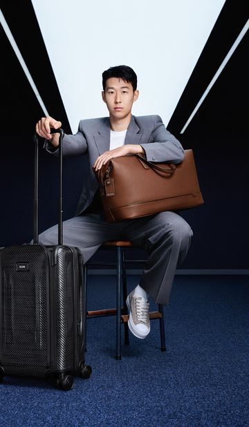 a man sitting on a chair with a suitcase